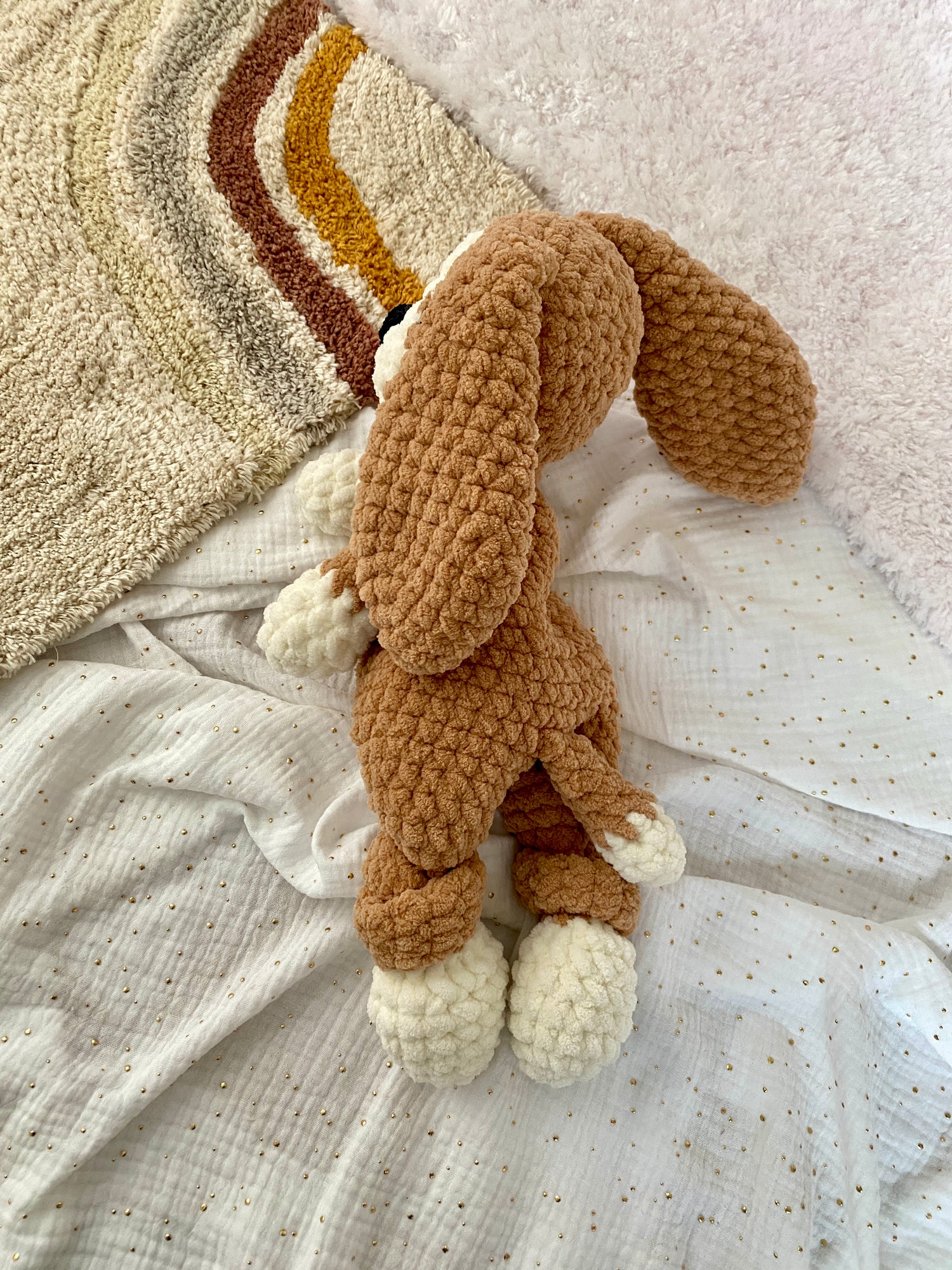 Side view of a crocheted Beagle dog lovey and snuggler, stuffed animal toy made with chenille yarn, ideal for children and emotional support.