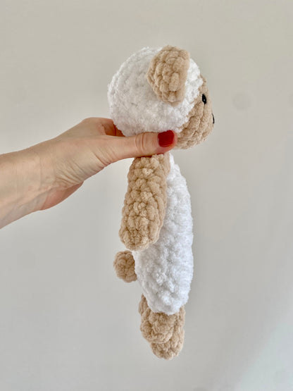 This side view showcases the detailed construction of the knotted lovey sheep design, featuring soft, textured stitches for the plushie’s body and simple knots forming the lovey’s arms and legs.